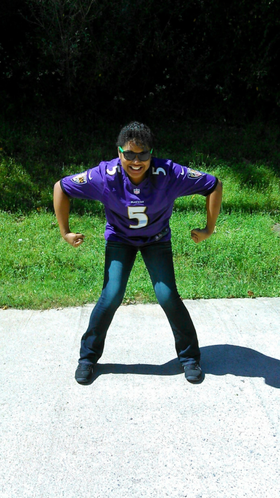 Shana CEO of Magnolia Heart Creative rocking a Baltimore Ravens football jersey number 5 in a funny pose